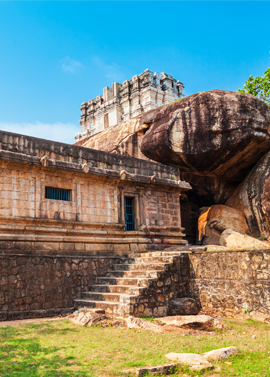 Ancient temple architecture in Kanyakumari surrounded by rocky landscape and blue sky - popular South India tourist attraction